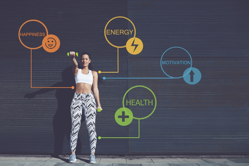 Photograph of fit woman in front of wall with health and wellness signs to illustrate, "Photograph of fit woman in front of wall with health and wellness signs to illustrate, "How A Ketogenic Diet Benefits Your Body And Mind".