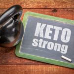 Photograph of a chalkboard with the words 'keto strong' and a kettle bell weight. Click to get your personalized custom keto diet plan.